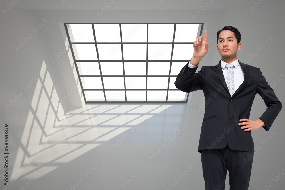 Poster Composite image of unsmiling asian businessman pointing
