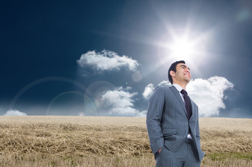 Composite image of smiling businessman standing