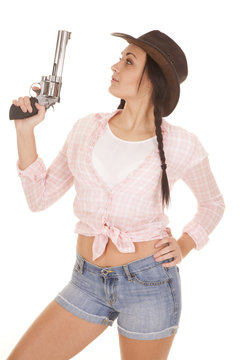 woman pink plaid shirt gun look side