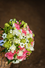 Beautiful bridal bouquet with golden rings in basket