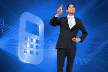 Composite image of smiling asian businessman pointing