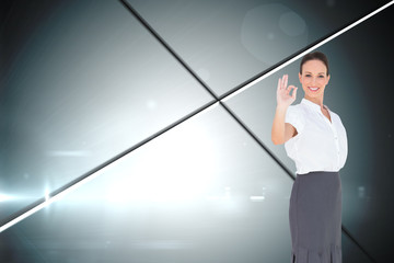 Fototapeta na wymiar Composite image of elegant businesswoman showing an okay gesture