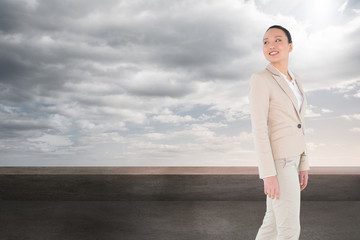 Composite image of smiling asian businesswoman