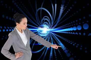 Composite image of unsmiling asian businesswoman pointing