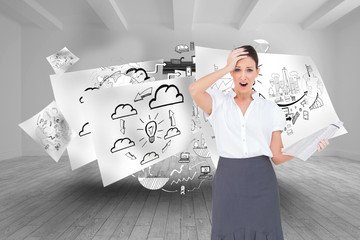 Fototapeta premium Composite image of shocked classy businesswoman holding newspape