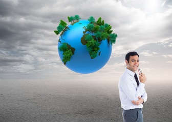 Composite image of smiling businessman holding glasses