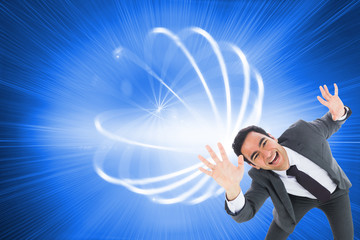 Composite image of excited businessman with arms raised