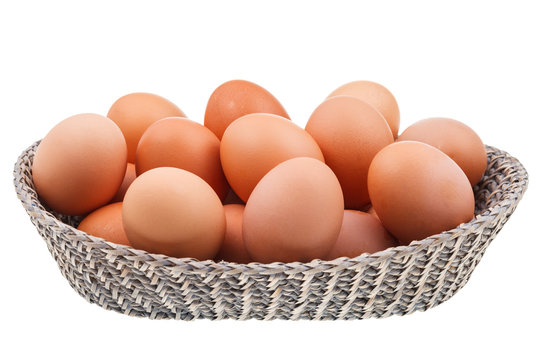 twenty fresh chicken eggs in wicker basket