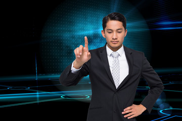 Composite image of unsmiling asian businessman pointing