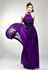 Beautiful fashion woman in violet long dress