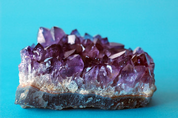Purple crystal amethyst on blue background