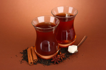 glasses of Turkish tea, on brown background