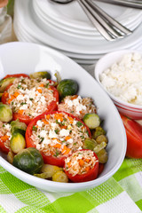 Stuffed tomatoes in bowl on wooden table close-up
