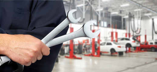 Hand with wrench. Auto mechanic.