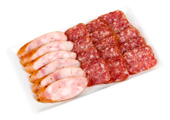 Tasty sliced sausage on plate isolated on white