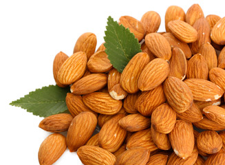 tasty almonds nuts with leaves, isolated on white