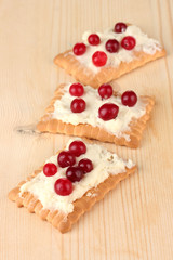 Cookie with cheese and cranberry, on wooden background