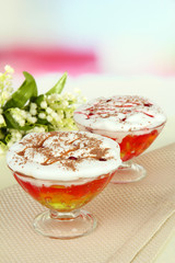 Tasty jelly in bowls on table on light background