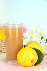 Sweet quince with juice on table on light background