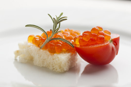 Perfect breakfast - Caviar sandwich with red cherry tomato on pl