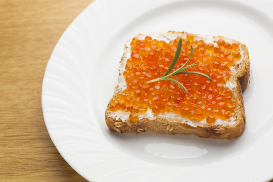Sendwich with Caviar on bread decorated with rosemery