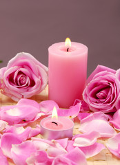 Fototapeta na wymiar Spa Candles and rose Petals on mat
