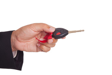 Business man holding a car key.