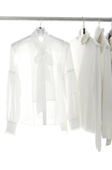 White female clothing on hangers at the show