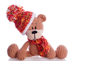 teddy bear with  scarf and bobble cap in winter