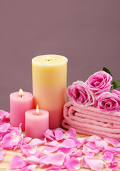 Obraz na płótnie Canvas spa setting with candle ,rose flower ,towel