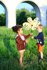 The boy passes wind spinner to the girl