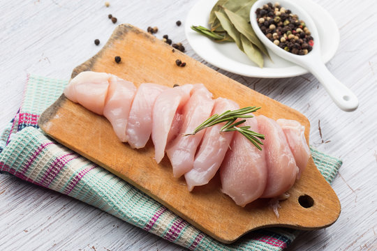 Fresh chicken on wooden board