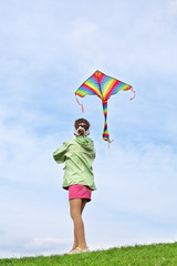 Back view of girl in pink skirt with kite