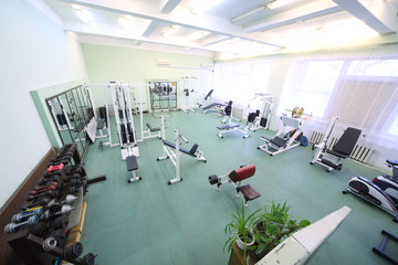 Top view on spacious empty gym with special equipment
