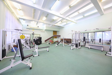 Spacious well lit empty gym with special equipment