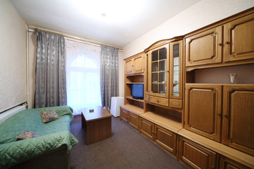 Living room with green sofa and a wall cabinet