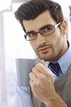 Closeup portrait of young man with mug