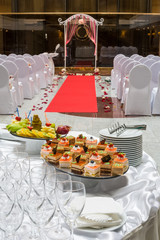 Empty hall for a wedding ceremony with table with snacks