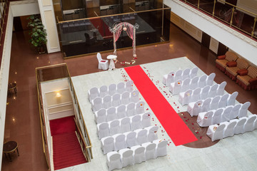 Empty hall for wedding ceremony with flower petals