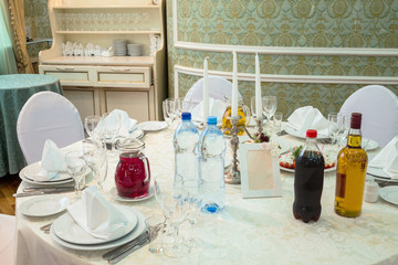 Elegant table with bottles in restaurant decorated for wedding