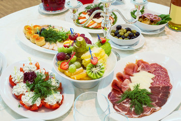 A variety of snacks of meat, fruit and vegetables
