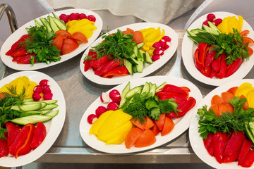 Six plates with fresh vegetables on a tray