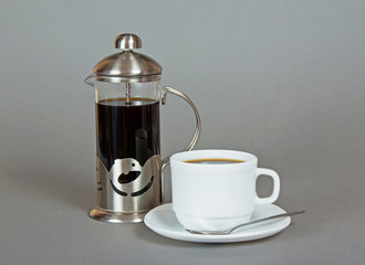 Coffee maker and cup of fragrant beverage