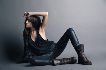 Fashion model wearing leather pants and jacket