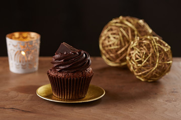 Black chocolate cupcake on Christmas background