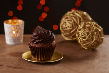 Black chocolate cupcake on Christmas background
