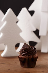 Black chocolate cupcake on Christmas background