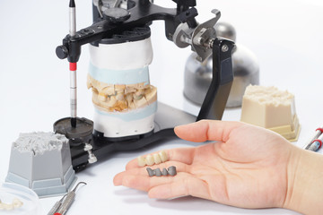Dental technician working with articulator in dental laboratory © pixs4u