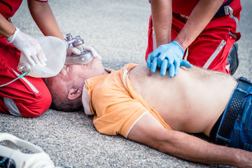 Paramedics succor a man with heart attack - obrazy, fototapety, plakaty