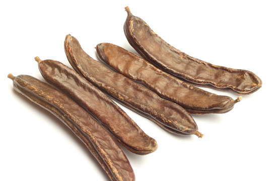 Carob pods isolated on white